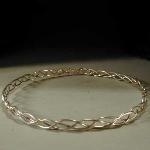 This is a simple appearing circlet made with three strands of sterling silver wire.  The circlet is 3/8-inch high.