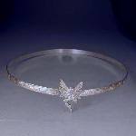 A fairy is set on this 1/3 inch sterling silver floral patterned band.